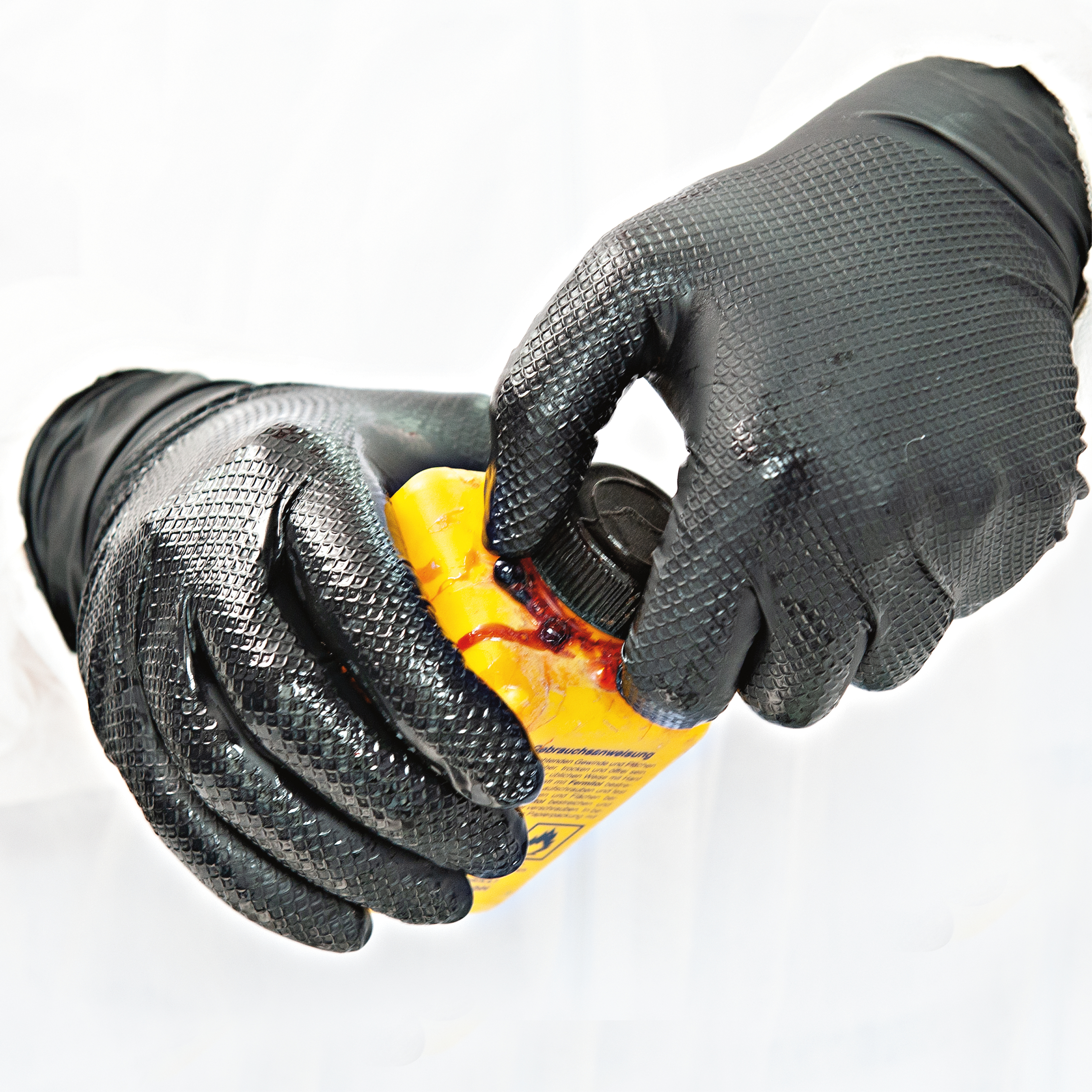 Nitrile gloves Power Grip, powder-free in black with example of use